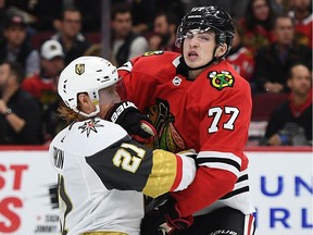 CHICAGO, ILLINOIS - OCTOBER 22:  Kirby Dach #77 of the Chicago Blackhawks collides with Cody Eakin #21 of the Vegas Golden Knights during the third period at the United Center on October 22, 2019 in Chicago, Illinois.