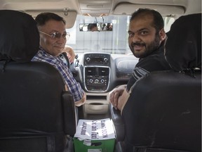 Mark Gill, left, and Zuhaib Jahangir pose for a photograph in a vehicle they plan to use for their new company Captain Taxi in Saskatoon, SK on Monday, July 8, 2019.