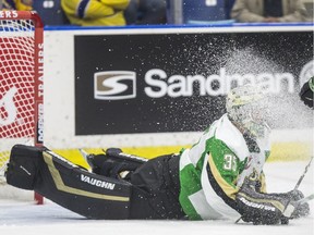 Prince Albert Raiders goalie Boston Bilous takes a face wash from the Saskatoon Blades in first-period WHL action at SaskTel Centre in Saskatoon on Saturday, September 21, 2019.