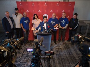 Jerry Dias, national president of Unifor, centre, speaks to media at the Hotel Saskatchewan regarding the pending strike of Saskatchewan Crown corporations.