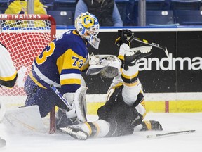 Saskatoon Blades goalie Nolan Maier deflects both the puck and the Brandon Wheat Kings forward during Western Hockey League action Sunday, Oct. 6, 2019 in Saskatoon, SK.