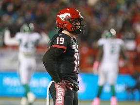 Calgary Stampeders Bo Levi Mitchell winces while watching a replay of an interception-return touchdown by the Saskatchewan Roughriders on Friday at McMahon Stadium. The pick-six was one of Mitchell's few miscues in a 30-28 Stampeders win.