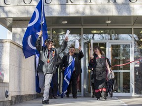 Jim Durocher, President of A La Baie Metis Local, left, and Ron Quintal, President of the Fort Mckay Mets Nation, lead a group of supports out of the Saskatoon Court of Queens Bench, following a filing of a land claim against the federal government for land that covers a large area of northern Alberta and Saskatchewan