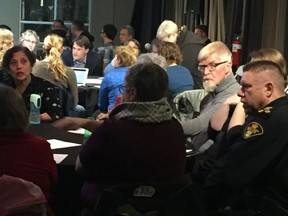 Saskatoon Police Chief Troy Cooper (right) and Commissioner Jo Custead  (left) speak with members of the community (centre) at Wednesday evening's community consultation at the Farmers Market. Oct. 16, 2019 (Thia James/ Saskatoon StarPhoenix)