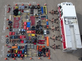Members of the Saskatoon Fire Department take part in the Tetris challenge, a viral meme where emergency services worldwide take a photograph of themselves laying on the ground alongside their laid-out equipment, at Fire Station 6 in Saskatoon, Sask. on Oct. 17, 2019.