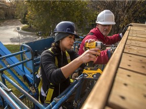 Des Wilson, left, and Darren Anderson, who work with EGADZ, works on a new deck at a new transitional housing project organized by EGADZ in Saskatoon, SK on Thursday, October 17, 2019. The apartment complex allows occupants to work on renovating the building before move-in in lieu of a damage deposit.