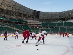 The Winnipeg Jets practise on the ice at Mosaic Stadium on Friday — one day before the NHL Heritage Classic between the Jets and Calgary Flames.