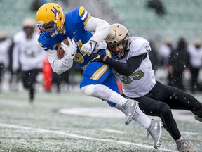 Saskatoon Hilltops receiver Dillan Heintz is tackled by Edmonton Huskies defensive back Mitchell Choma-Phillips during the Prairie Football Conference championship game at SMF Field in Saskatoon, SK on Sunday, October 27, 2019.