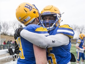 Saskatoon Hilltops linebacker Jadyn Pingue, right, and defensive linemen Jesse McNabb, left, celebrate their victory over the Edmonton Huskies in the Prairie Football Conference championship game at SMF field in Saskatoon on Sunday, October 27, 2019.