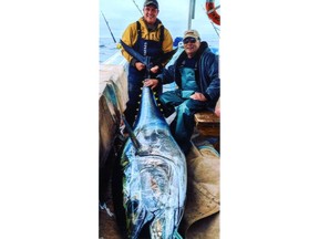 Gerry Dunning and his son Zak with a 450-pound bluefin tuna they caught.