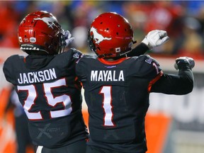 Calgary Stampeders Hergy Mayala celebrates a touchdown with teammate Don Jackson on Friday, when the visiting Saskatchewan Roughriders fell 30-28.