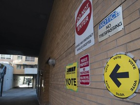 Signs point towards an advance voting poll location at the electoral district of Toronto Centre at Muriel Collins Housing Cooperative in Toronto on Friday Oct. 11, 2019.
