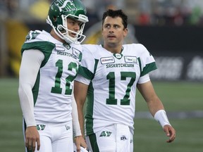 Zach Collaros, 17, leaves the field alongside kicker Brett Lauther, 12, after the Saskatchewan Roughriders quarterback sustained a concussion in the CFL's regular-season opener against the host Hamilton Tiger-Cats on June 13. Collaros has yet to play since that game, but he has twice been traded — first to the Toronto Argonauts, and now to the Winnipeg Blue Bombers.