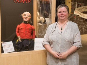 RCMP Historical Collections Unit curator Jodi Ann Eskritt stands next to ventriloquist dummy "Oliver" in the Black Museum exhibition.