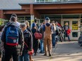 People line up to vote at a polling station for Canada's 43rd general election October 21 in Toronto, Ontario, Canada.