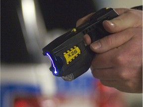 A Saskatoon Police officer displays the energy emitted from a Taser stun gun.