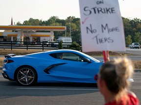 Kai Spande, manager of the General Motors assembly plant, drives his 2020 Chevrolet Corvette past striking auto workers outside the plant in Bowling Green, Kentucky, September 30, 2019. (REUTERS/Bryan Woolston/File Photo)