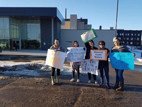 (Left to right) Logan Church, Shannon Michel, Nikita McKinnon, Kirsten Fritsch and Jan Unruh demonstrate in front of the Flin Flon General Hospital in March 2019. Obstetric services in the facility were suspended in November 2018 due to a lack of a physician to perform them.(Supplied/photo courtesy of Jan Unruh)