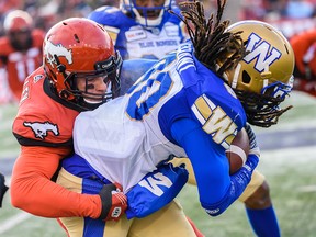 Calgary Stampeders Nate Holley stops Winnipeg Blue Bombers Janarion Grant during the CFL's West Division semifinal at McMahon Stadium on Sunday, November 10, 2019. Azin Ghaffari/Postmedia Calgary