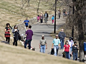 People walk on the crowded Meewasin Trail through the downtown in this April 24, 2011 photo.