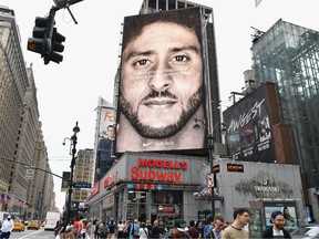 In this file photo taken on September 08, 2018 a Nike Ad featuring American football quarterback Colin Kaepernick is on diplay in New York City.