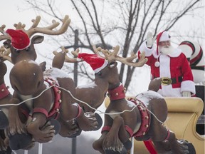 Santa Claus waves at attendees during the Santa Claus Parade in Saskatoon.