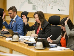 From left, Coun. Zach Jeffries, Coun. Ann Iwanchuk and Coun. Sarina Gersher vote during a city council meeting on Monday, Sept. 30, 2019.