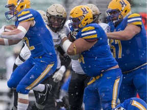 Saskatoon Hilltops offensive lineman Ryder Klisowsky (61), shown here in the middle blocking for ball carrier Ben Abrook, will finish off his CJFL career at the 2019 Canadian Bowl in Langely, B.C.