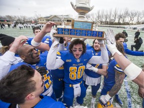 SASKATOON,SK--OCTOBER 27/2019-1028 Sports Hilltops PFC final- Saskatoon Hilltops receiver John Brown lefts the Paul Schwann Memorial Cup as he and his team celebrate their victory over the Edmonton Huskies in the Prairie Football Conference championship game at SMF field in Saskatoon, SK on Sunday, October 27, 2019.