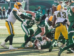 The Roughriders' Marcus Thigpen reaches for the goal line to score on a four-yard run — the Roughriders' only offensive touchdown in Saturday's victory over the visiting Edmonton Eskimos.