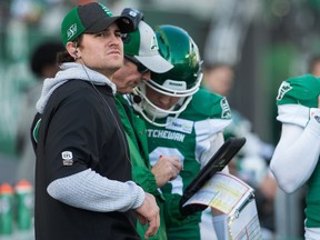 Saskatchewan Roughriders injured starting quarterback Cody Fajardo (7), left, stands on the sidelines with the teams other two quarterbacks during a CFL football game against the Edmonton Eskimos at Mosaic Stadium.
