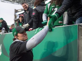 Saskatchewan Roughriders quarterback Cody Fajardo, who sat out due to injury on Saturday, accepts congratulations from the fans at Mosaic Stadium after the team clinched first place in the West Division.