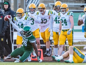 The Huskies' Nelson Lokombo, shown after a playoff interception against Alberta this month, is the top defensive player in the nation.