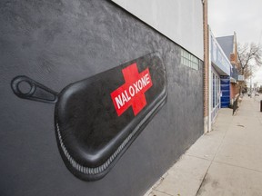 A large mural of a Naloxone kit on the front of AIDS Saskatoon's new supervised consumption site, next to the province's first needle exchange.