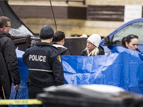 Saskatoon police responded on Nov. 8, 2019 to the discovery of an infant's body in a recycling bin the 400 block of Fifth Avenue North. Officers were called around 8:50 a.m. following a report of "an unknown problem." (Matt Smith / Saskatoon StarPhoenix)