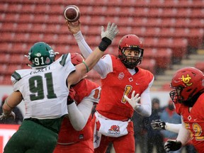 Calgary Dinos quarterback Josiah Joseph throws a pass under pressure from the University of Saskatchewan Huskies' Riley Pickett during the Hardy Cup at McMahon Stadium in Calgary on Saturday November 9, 2019. Calgary won the game 29-4.