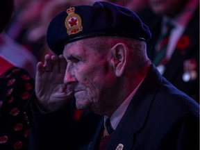 Harold Martinson, a veteran of the Second World War, salutes during the Remembrance Day Ceremony at SaskTel Centre in Saskatoon.