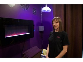 Anne-Marie Howie, CEO and owner of Essential Power Inc., shows off her "home automation" -- smart lights and speakers -- in her Saskatoon home on Nov. 8, 2019.