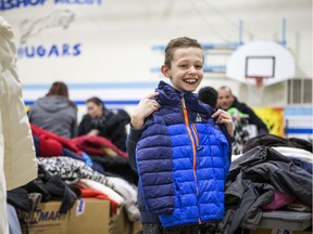 Nicholas Krawetz, 9, picks out a coat during the Rock 102 Coats for Kids Campaign at Bishop Klein School in Saskatoon, Sask. on Nov. 13, 2019.