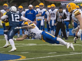 Saskatoon Hilltops defensive end Tristan Hering (65) makes a diving tackle on Langley Rams quarterback Tristan Secord-Yanciw. Hering was named the defensive MVP of the 2019 Canadian Bowl. (Photo by Francis Georgian/Postmedia)
