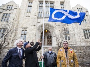 President Peter Stoicheff, Glen McCallum, Earl Cook, and Norman Fleury, (left to right) raise a Metis flag in front of the Thorvaldson Building at the University of Saskatchewan. The Metis Nation-Saskatchewan and The University of Saskatchewan signed a memorandum of understanding designed to improve the education status of Metis people. Photo taken in Saskatoon, Sask. on Nov. 18, 2019.