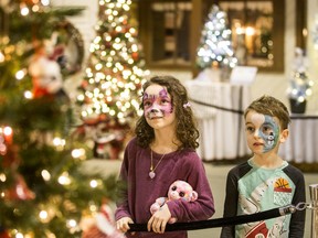 Nora, left, and Jack enjoy the Festival of Trees at the Western Development Museum in Saskatoon, Sask. on Nov. 25, 2019.