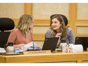 Ward 6 Coun. Cynthia Block, left, and Ward 7 Coun. Mairin Loewen converse at city council budget talks in Saskatoon on Nov. 25.