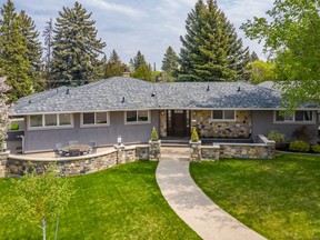 This mid-century modern bungalow at 401 Lake Crescent in Grosvenor Park was totally transformed inside and out by Atmosphere Interior Design. The front exterior of the home features a unique stone wall, inspired by the homeowners' travels to the Mediterranean. A German mason hand-carved each stone in the wall.  Photo: Scott Prokop Photography