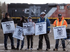 Striking CN rail workers stand out front at the CN rail yards on 1st Avenue North in Regina on Nov. 19, 2019.