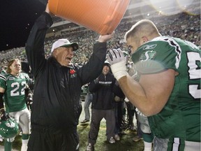 Saskatchewan Roughriders head coach Ken Miller, left, dumps the remaining contents of a Gatorade bucket on centre Jeremy O'Day, left, after the team clinched first place in the West Division by defeating the Calgary Stampeders 30-14 at Taylor Field on Nov. 7, 2009. O'Day is now the general manager of the Roughriders, who can clinch first place Saturday by defeating the visiting Edmonton Eskimos at Mosaic Stadium.