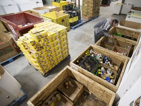 Volunteer Cal Carr sorts food items at the Saskatoon Food Bank in Saskatoon.