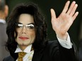 In this file photo taken on June 3, 2005, Michael Jackson waves as he arrives at the Santa Barbara County courthouse in Santa Maria, Calif.