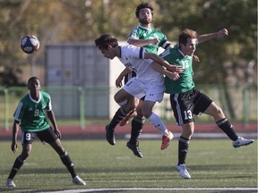 Jacob Powell (middle) leaps high into the air to play a ball for the University of Saskatchewan Huskies.