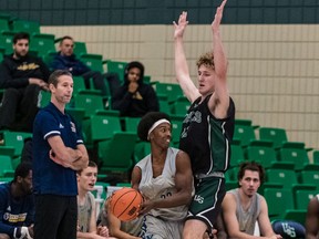 Saskatchewan Huskies forward Ryker Wuttke, shown here covering Laurentian Voyageurs guard Haroun Mohamed at the Ron and Jane Graham Shootout men's basketball tournament in Saskatoon, is a project player with a high ceiling.